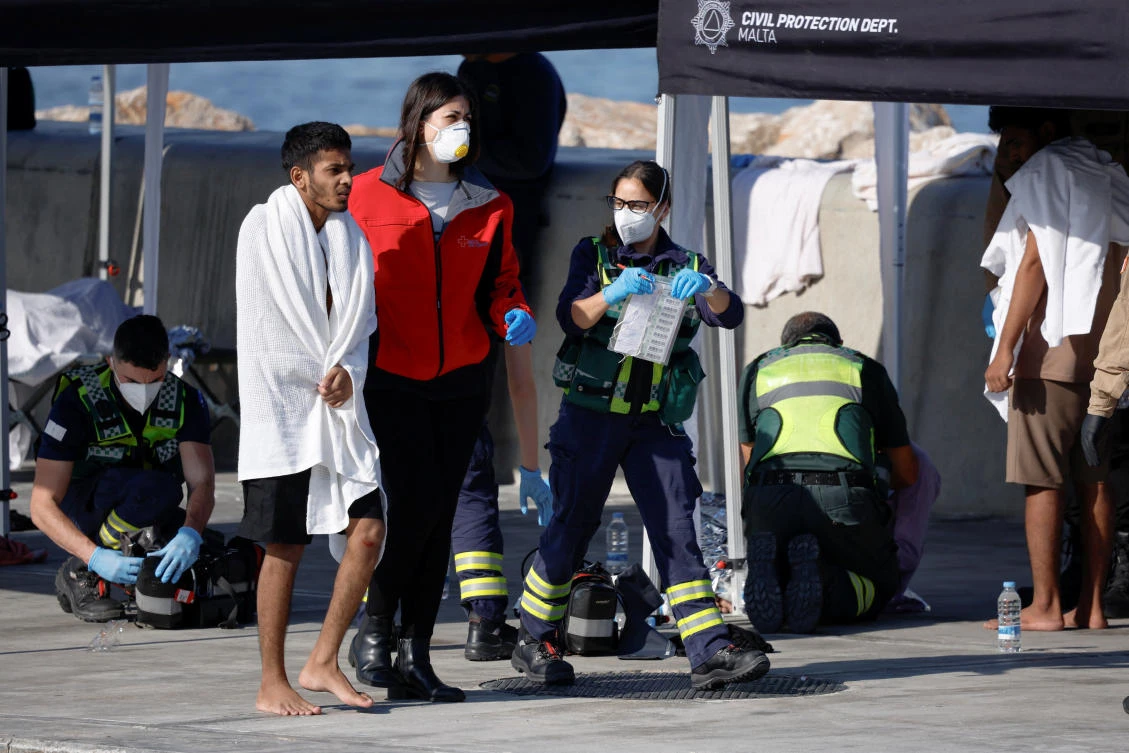 Medics assist a migrant after a group of some 60 migrants was brought to Malta after their boat capsized close to the Mediterranean island, in Bugibba, Malta, Dec. 12, 2025. (Reuters)