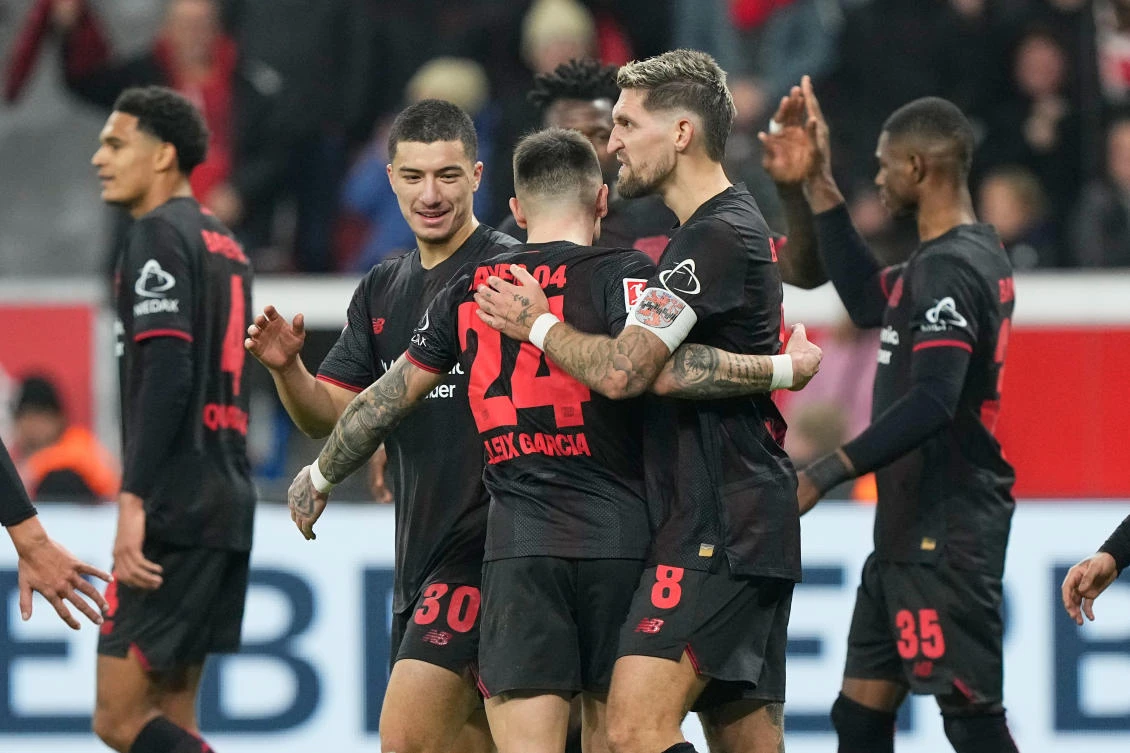 Leverkusen’s Robert Andrich is celebrated after he scored his side’s second goal during their Bundesliga match against 1.FC Cologne in Leverkusen, Germany, Dec. 13, 2025. (AP)
