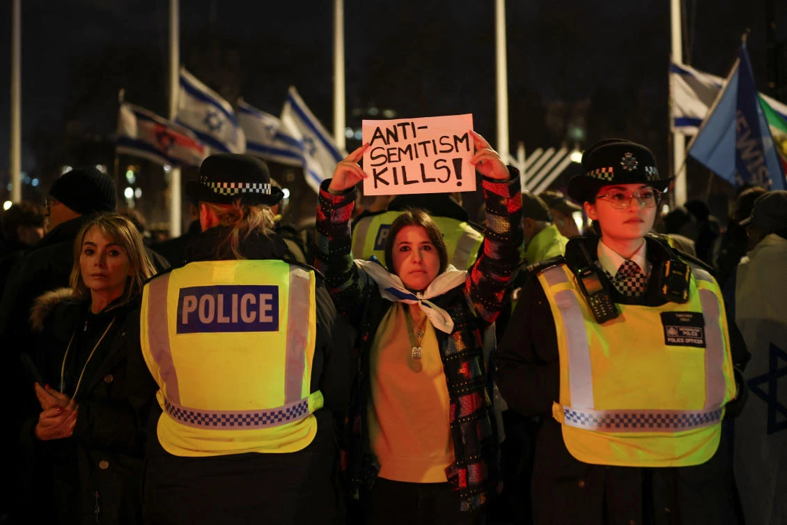 People attend a vigil organised by the Campaign Against Antisemitism and Chabad UK to honour victims of the Bondi attack in Sydney and mark the second night of Hanukkah, in London on Monday. (Reuters)