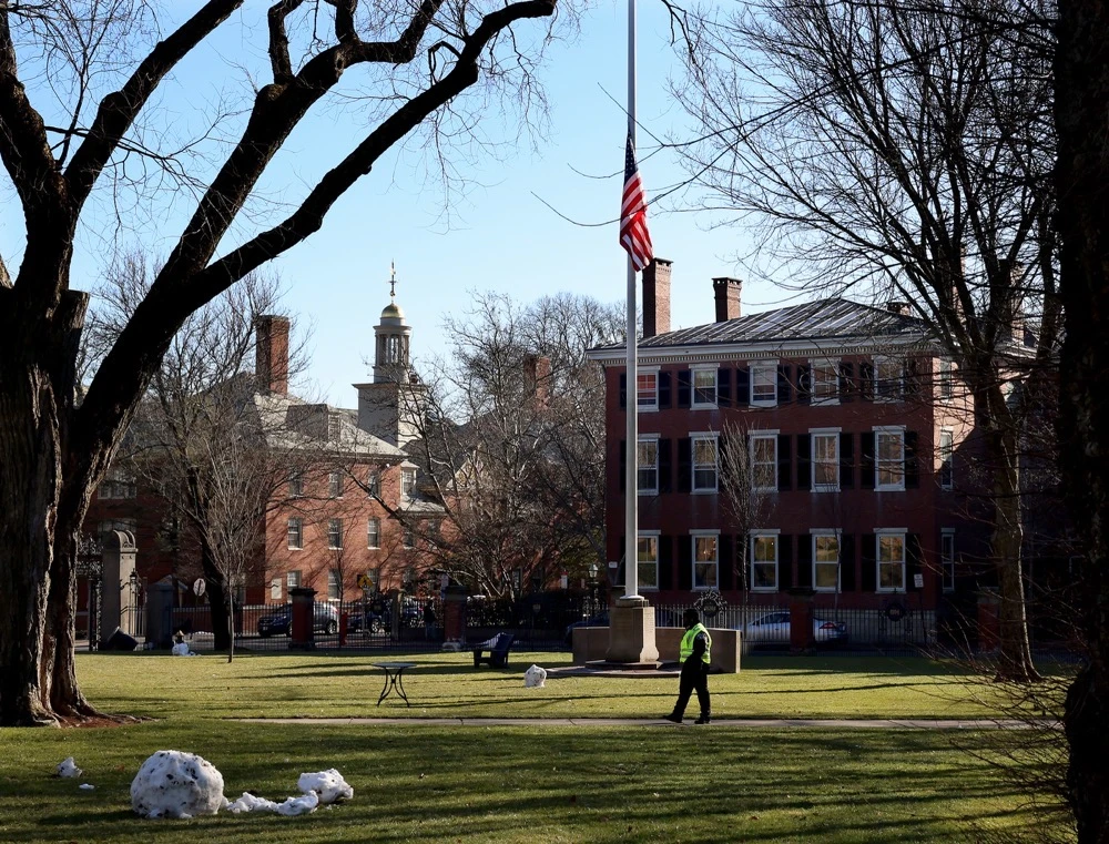 A security guard walks past a flag at half-staff on the main green of Brown University in Providence, RI, Thursday, Dec. 18, 2025. (AP)