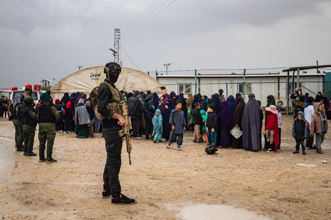 Fighters stand guard during a joint security operation for Syria's Kurdish Internal Security Police Force at camp Roj, Syria. (AFP)