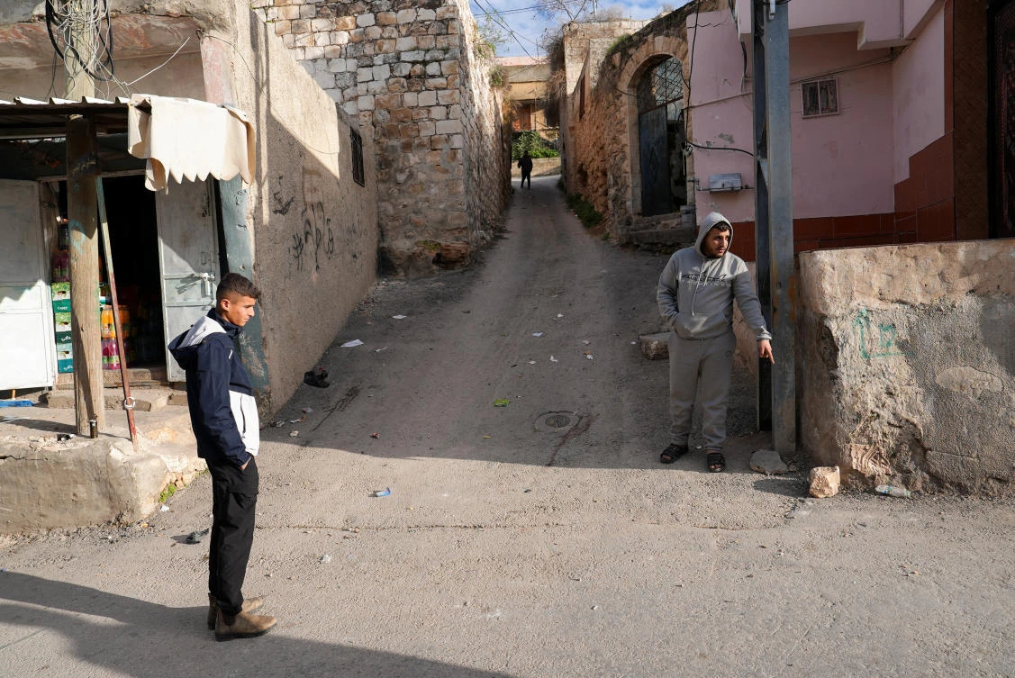 Witness Kamel Zakarneh points where 16-year old Palestinian Rayyan Abu Mualla was killed by Israeli forces during a raid, in Qabatiya in the Israeli-occupied West Bank on Saturday. (Reuters)