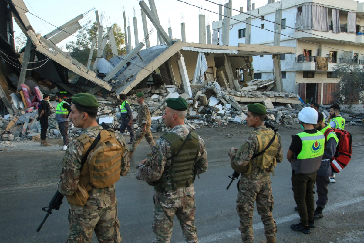 Lebanese army soldiers secure the site of an Israeli airstrike that targeted a building in the southern Lebanese village of Deir Kifa on November 19, 2025. (AFP)