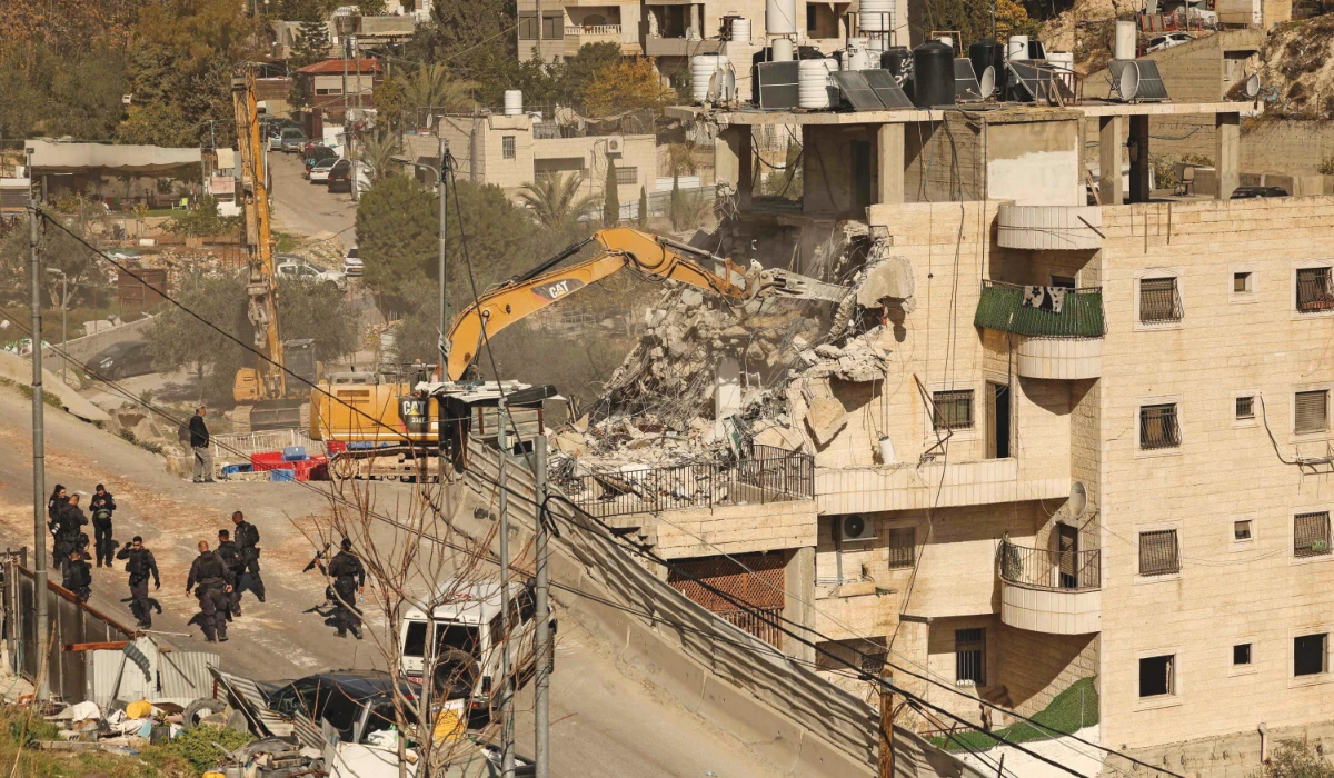 Israeli security forces gather as excavators demolish a building constructed without a permit in the Wadi Qaddum area near the Silwan neighbourhood of east Jerusalem on December 22, 2025. (AFP)