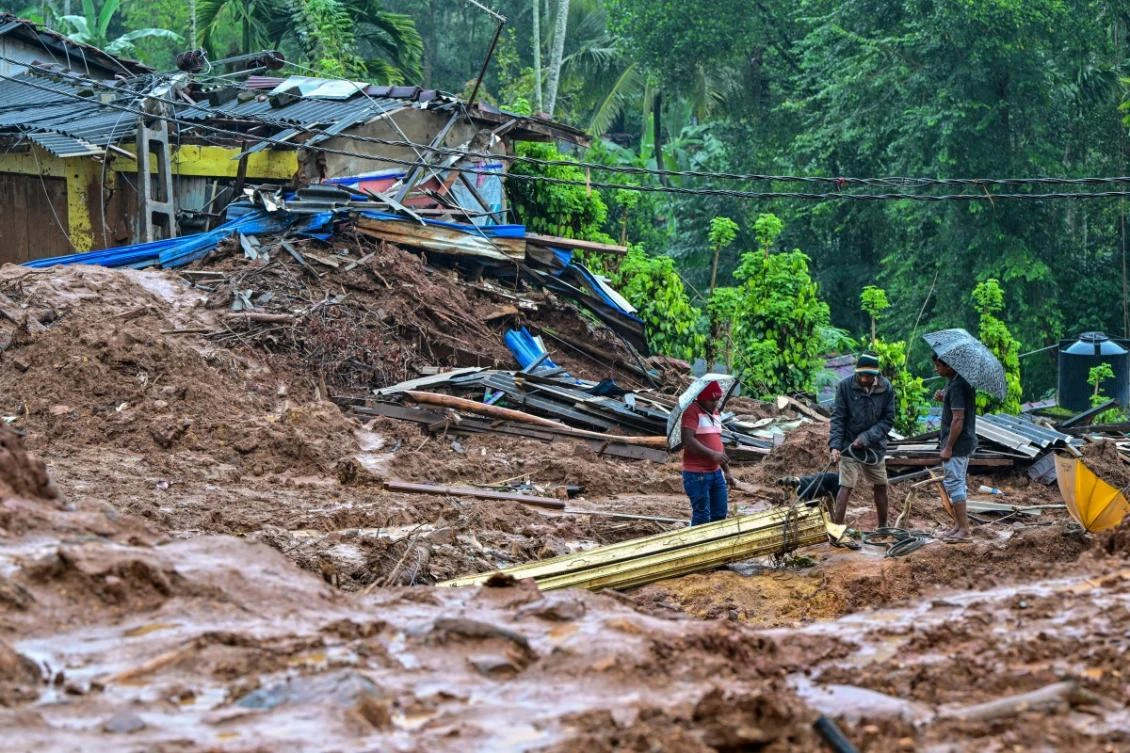 People work near a damaged house at a landslide-affected area in the aftermath of Cyclone Ditwah, in Maspanna on December 13, 2025. (AFP)
