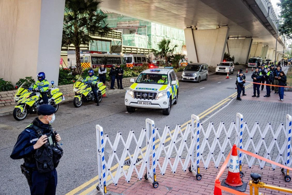 Police are seen outside the West Kowloon court ahead of the verdicts in media tycoon Jimmy Lai's national security trial in Hong Kong on December 15, 2025.(AFP)