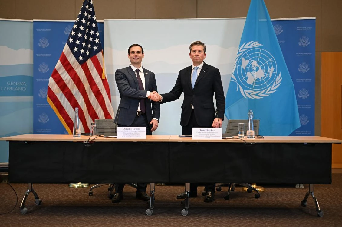 US Under Secretary of State for Foreign Assistance, Humanitarian Affairs and Religious Freedom Jeremy Lewin (L) shakes hands with United Nations Under-Secretary-General for Humanitarian Affairs Tom Fletcher during the signing ceremony of a $2 billion pledge of United States for United Nations humanitarian aid in 2026, at the US Mission in Geneva, on December 29, 2025. (AFP)