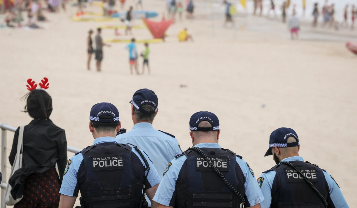 Police officers patrol near beachgoers on Christmas Day at Bondi Beach in Sydney on December 25, 2025. (AFP)
