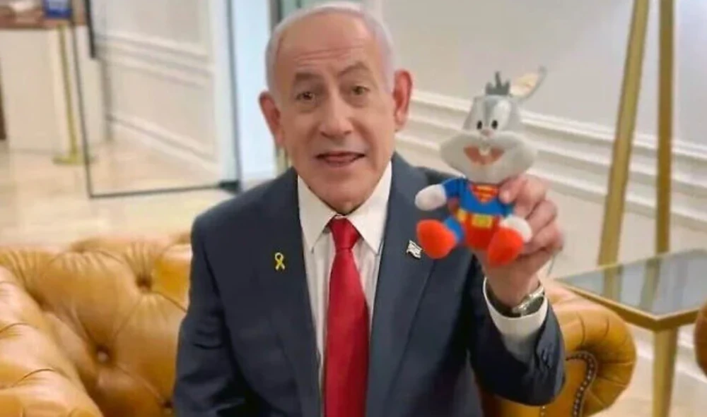 Prime Minister Benjamin Netanyahu holds up a Bugs Bunny doll in a video decrying his ongoing trial. (X/Screenshot)