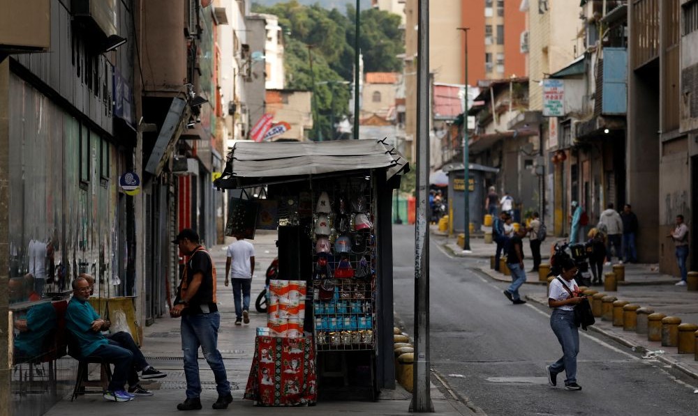 People talk near a kiosk following the capture of Nicolas Maduro and Cilia Flores, Caracas, Venezuela, Jan. 7, 2026. (Reuters)