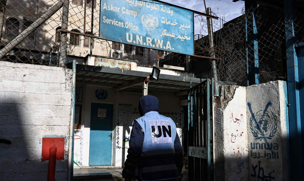 A man enters a building of the United Nations Relief and Works Agency for Palestine Refugees (UNRWA) in the Askar camp for Palestinian refugees, east of Nablus in the Israeli-occupied West Bank, on December 31, 2025. (AFP)