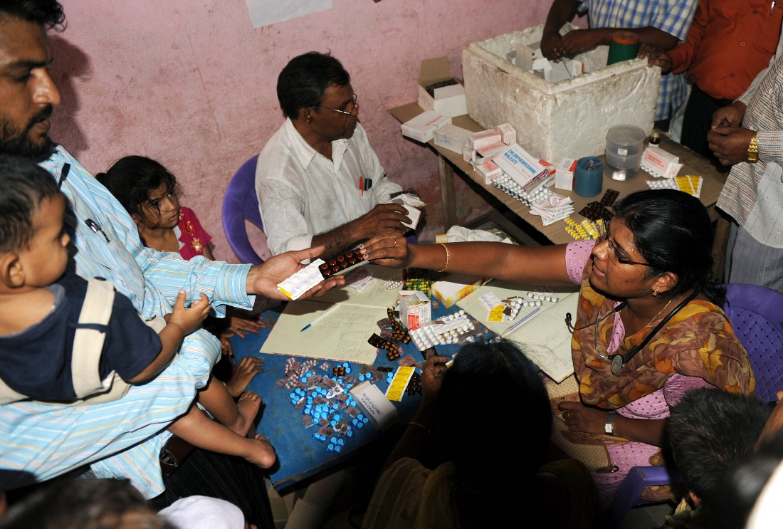 A photo dated 2009 shows Indian medical personnel distrubute medicine to patients in Hyderabad after consuming contaminated water in India. (AFP)