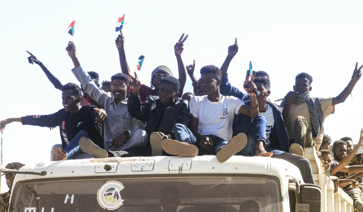 Sudanese take to the street during a rally in support of the Sudanese regular army in their battle against the paramilitary Rapid Support Forces (RSF) in Omdurman, part of greater Khartoum on December 13, 2025. (AFP)
