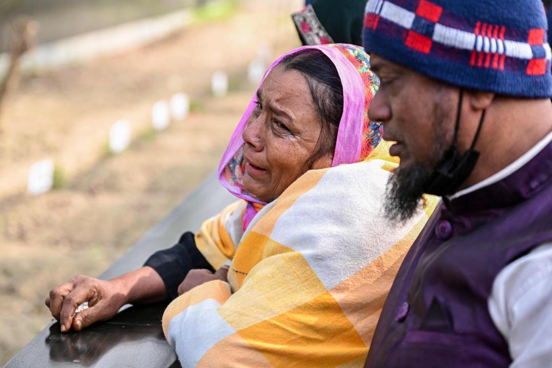Family members mourn at a grave of their relative, a victim of the July 2024 uprising, after its identification by an investigative commission at the Rayerbazar Graveyard in Dhaka on January 5, 2026. (Photo by Munir UZ ZAMAN / AFP)