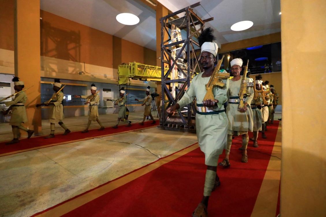 Workers move the statue of the 7th century BC King Taharqa of the 25th Kushite empire dynasty from the entrance of the Sudan National Museum to a new location within. (File/AFP)