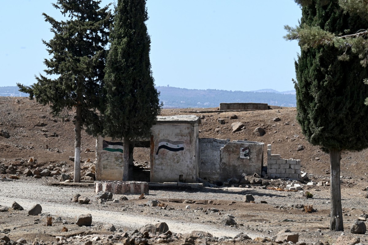 The flags of Palestine and Syria are displayed on an abandoned military base near the city of Quneitra in southern Syria, on the edge of the Israeli-annexed Golan Heights, Sept. 21, 2025. (AFP)