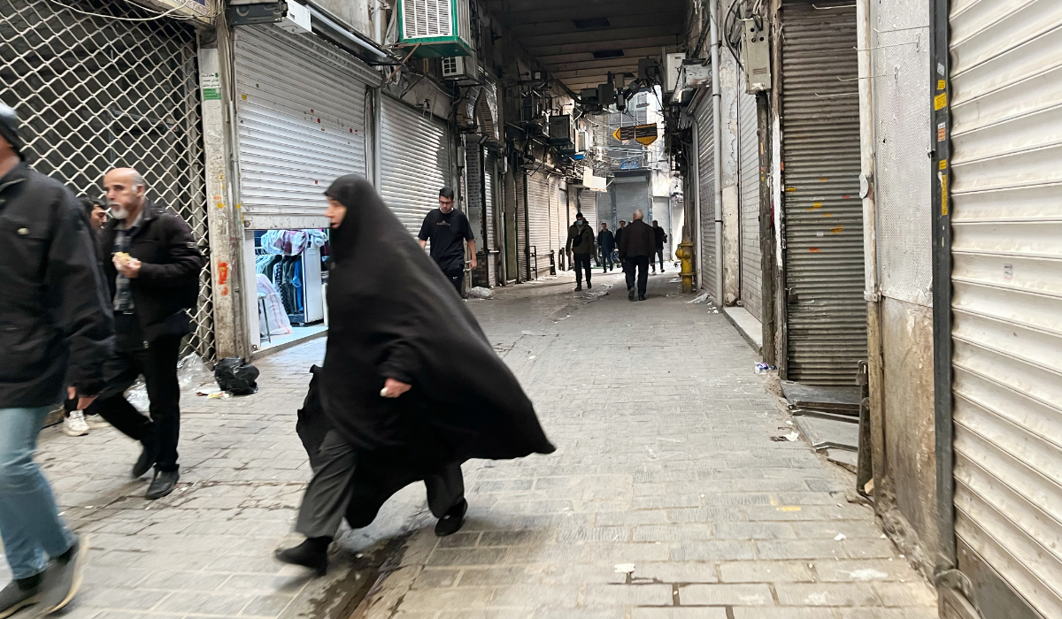 People walk as shops are closed during protests in Tehran's centuries-old main bazaar, Iran, Tuesday, Jan. 6, 2026. (AP)