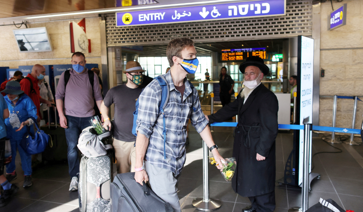 Tourists walk at the Ben Gurion International Airport after entering Israel by plane in Lod, near Tel Aviv, Israel, May 27, 2021. (REUTERS)