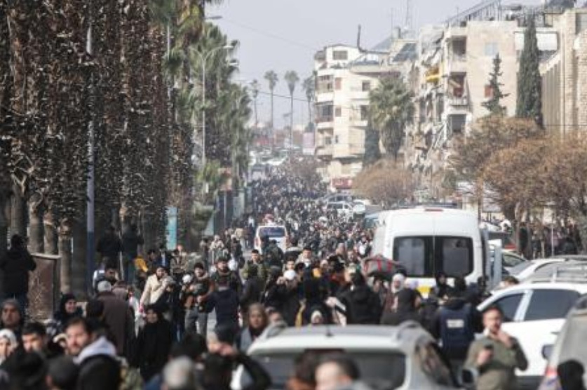 Residents carry their belongings as they flee Aleppo’s Ashrafieh Kurdish neighborhood on Jan. 7, 2026. (AFP)