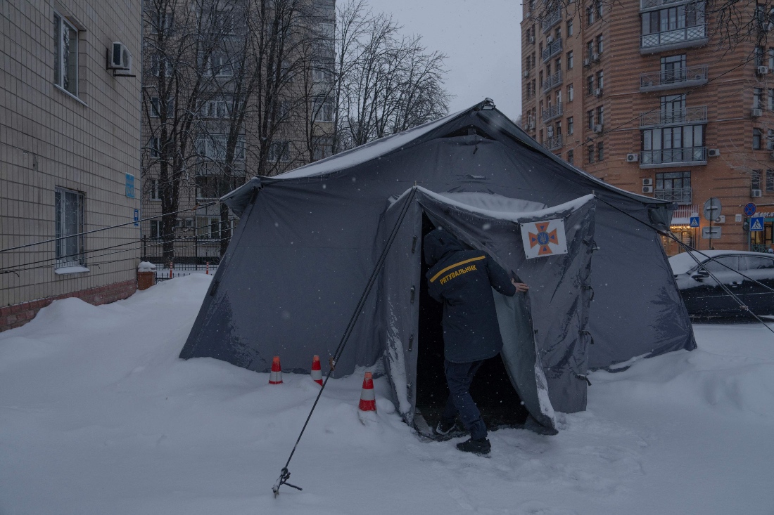 A Ukrainian rescue worker opens a tent of Point of Invincibility in Kyiv, Ukraine. (AFP)