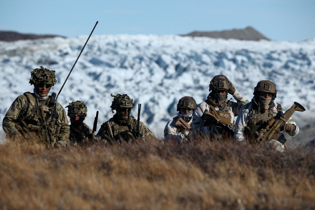 Members of the Danish armed forces practice looking for potential threats during a military drill as Danish, Swedish and Norwegian home guard units together in Greenland. (Reuters)