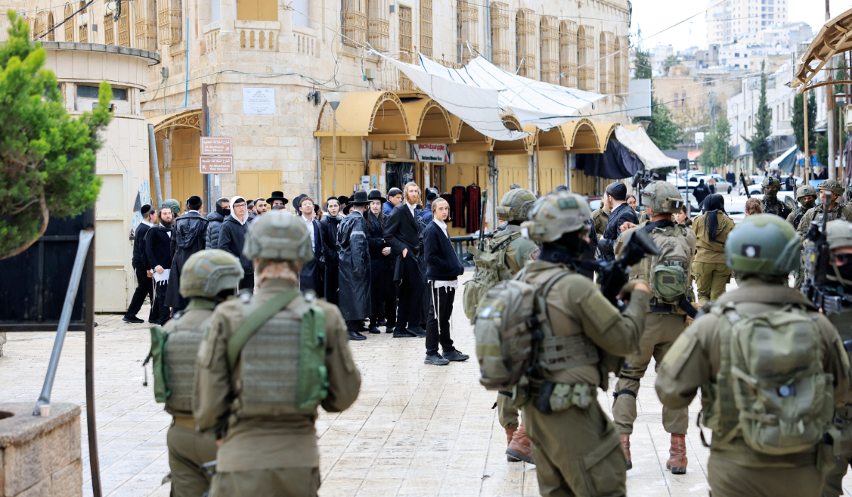 Israeli soldiers stand guard during a weekly settlers’ tour in Hebron in the Israeli-occupied West Bank on Saturday. (Reuters)