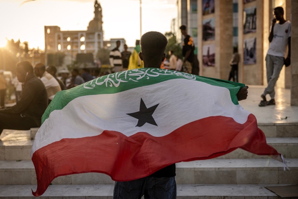 A man holds a flag of Somaliland in front of the Hargeisa War Memorial monument in Hargeisa. (AFP/File)
