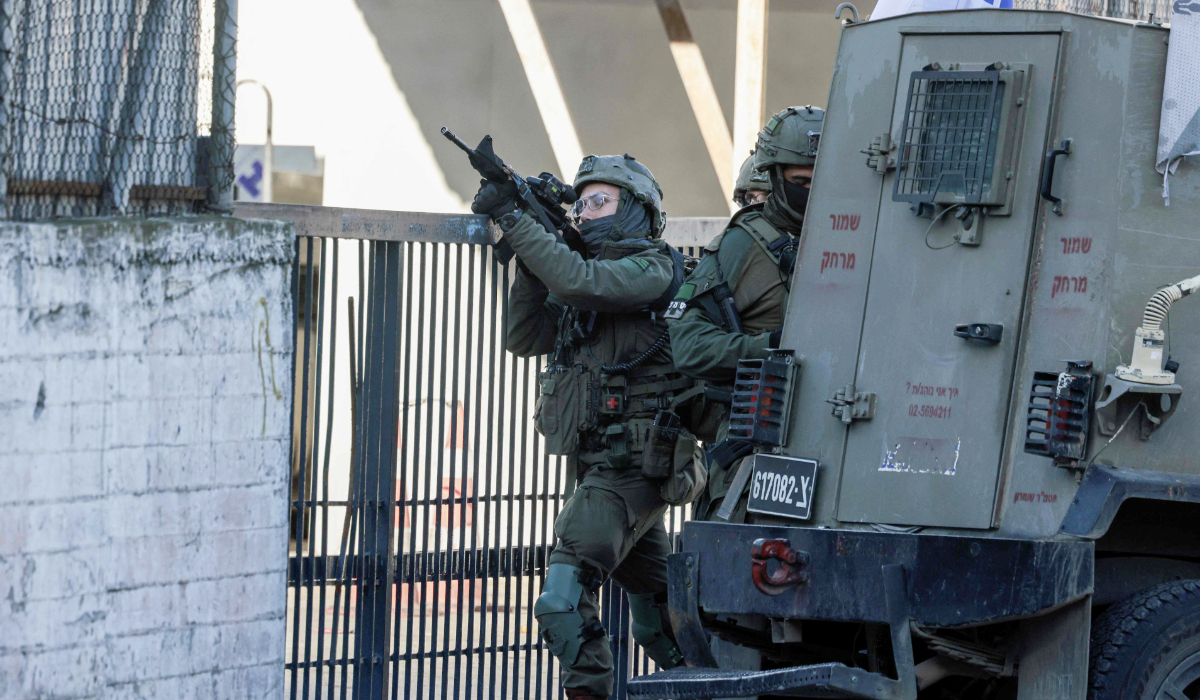 Israeli soldiers take positions during a military operation, around the old city of the Israeli-occupied northern West Bank city of Nablus on January 11, 2026. (AFP)
