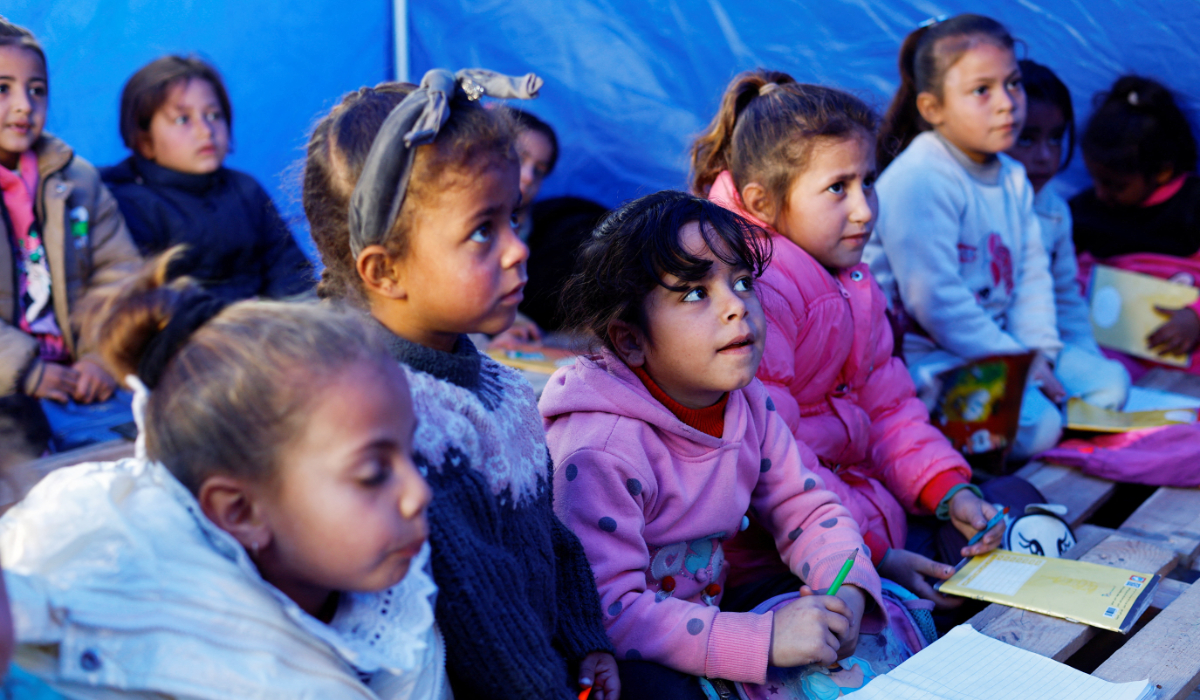 Displaced Palestinian students study inside a tent near the Israeli-designated "yellow line" in Beit Lahiya, northern Gaza Strip, January 6, 2026. (REUTERS)