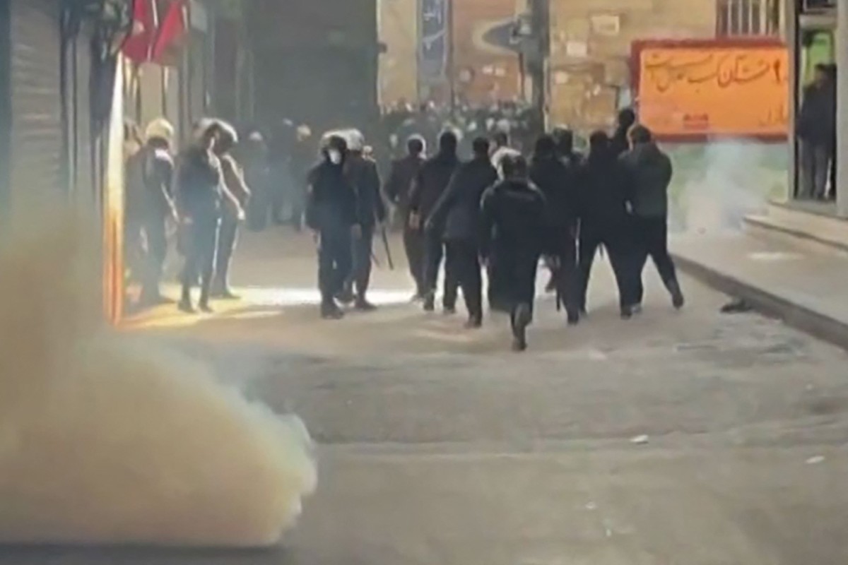 This grab taken on January 6, 2026, from UGC images posted on social media the same day shows Iranian security forces using tear gas to disperse protesters at the Tehran bazaar. (File/AFP)