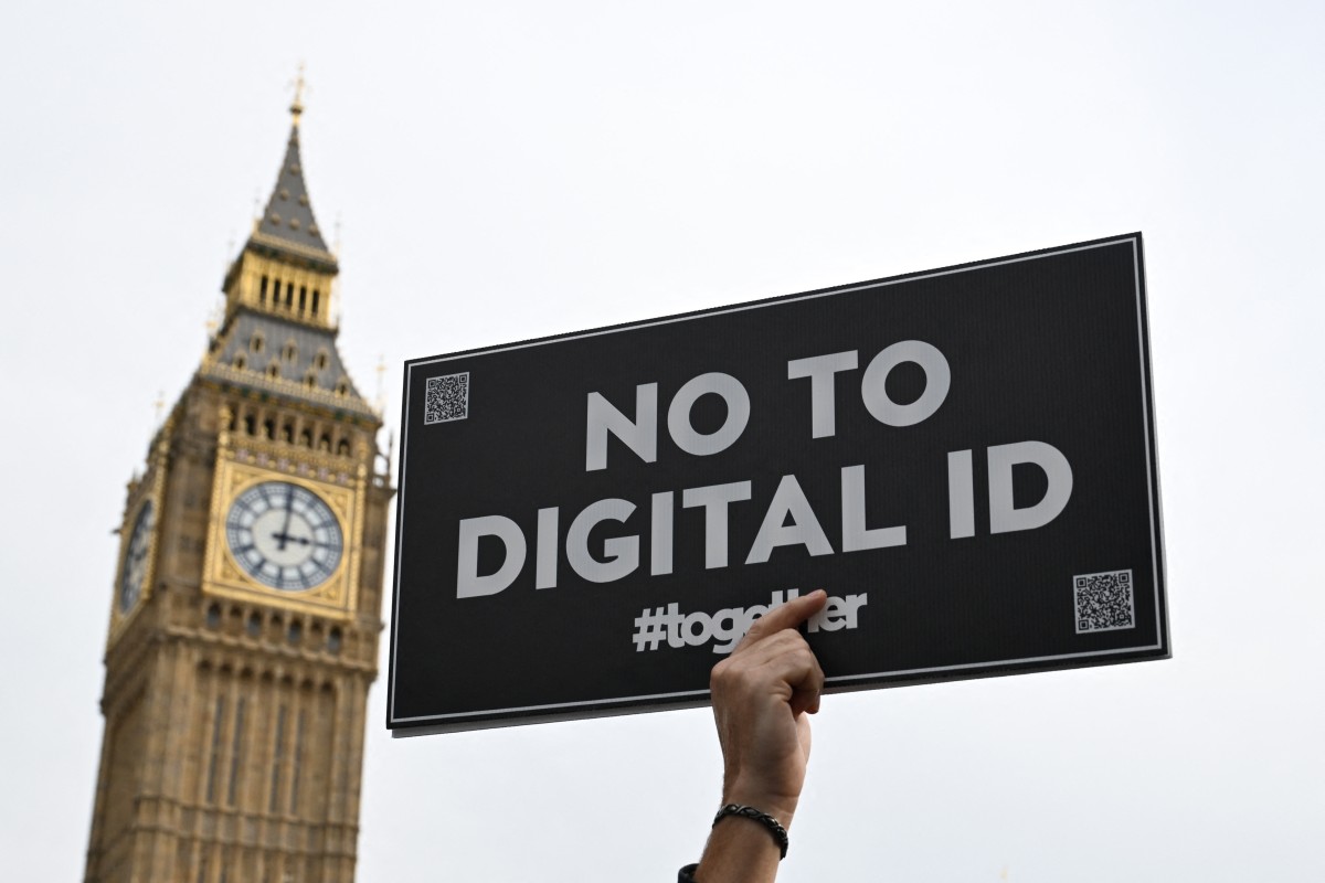 A demonstrator holds up a placard outside The Palace of Westminster during a march against the implementation of digital ID cards, in central London, Oct. 18, 2025. (AFP)