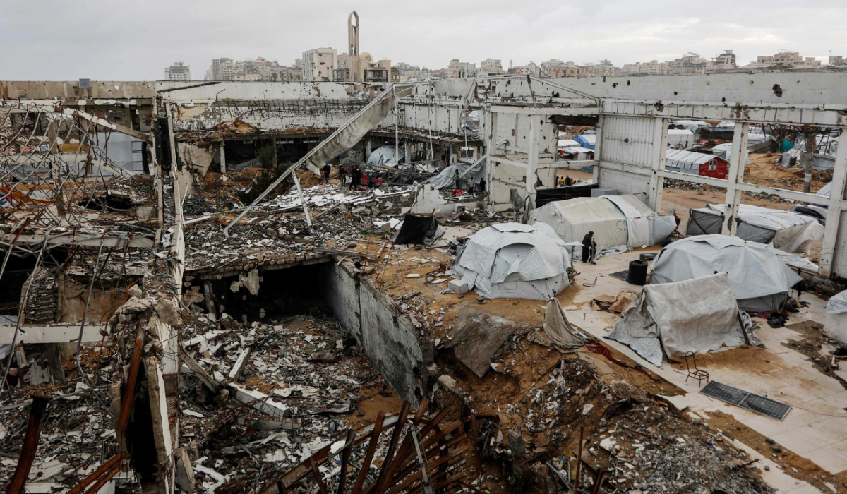 A photograph shows makeshift shelters inside a war-damaged building, parts of which collapsed on a windy winter day in Gaza City on January 13, 2026. (AFP)