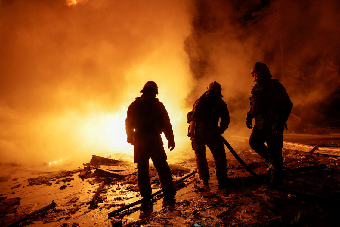 Firefighters work at the site of a logistics hub of a private delivery company hit by a Russian missile strike, amid Russia's attack on Ukraine, in Kharkiv, Ukraine January 13, 2026. (REUTERS)