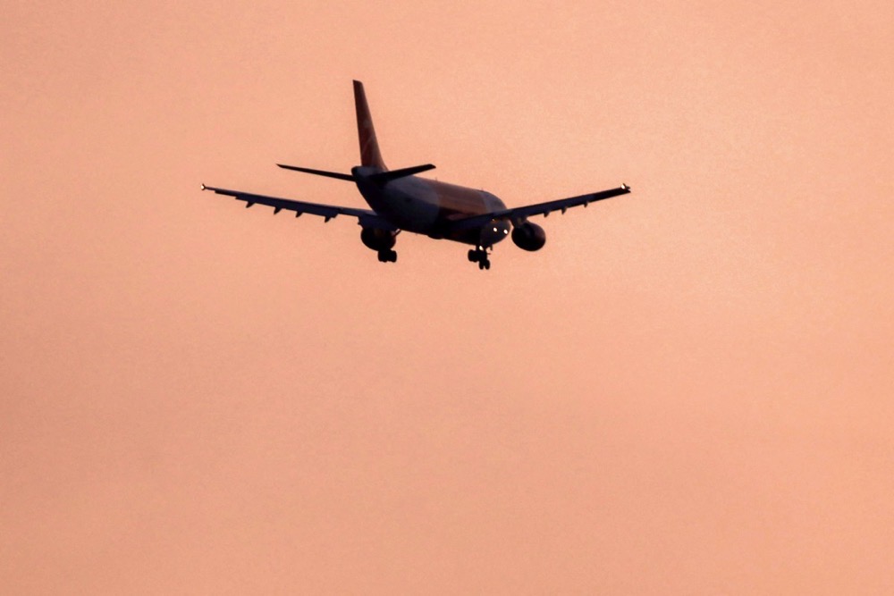 An Airbus A320 aircraft of Iranian airline Qeshm Air flies over Shamiya district on its landing approach to Najaf International Airport in central Iraq. (AFP/File)