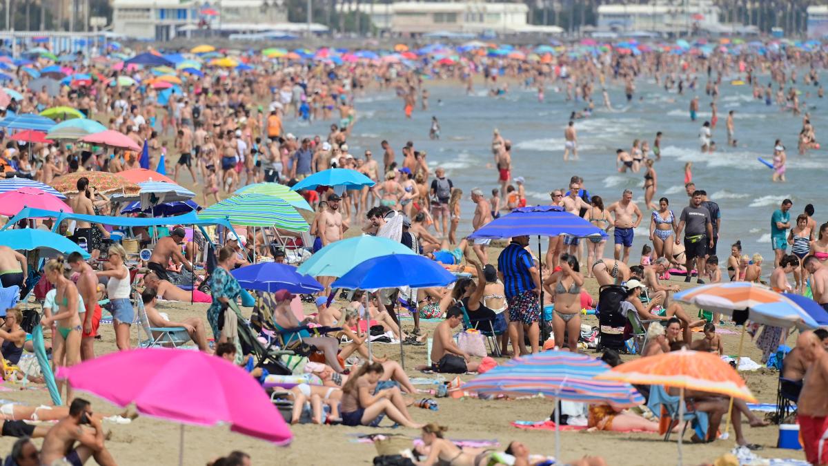 People sunbathe on Malvarrosa beach, Valencia, on Aug. 3, 2025. (AFP)