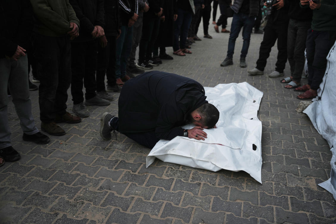 Palestinians mourn the body of Saeed Al-Jaro, killed in an Israeli military strike, during his funeral at Al-Aqsa Hospital in Deir Al-Balah, Gaza on Thursday (AP)