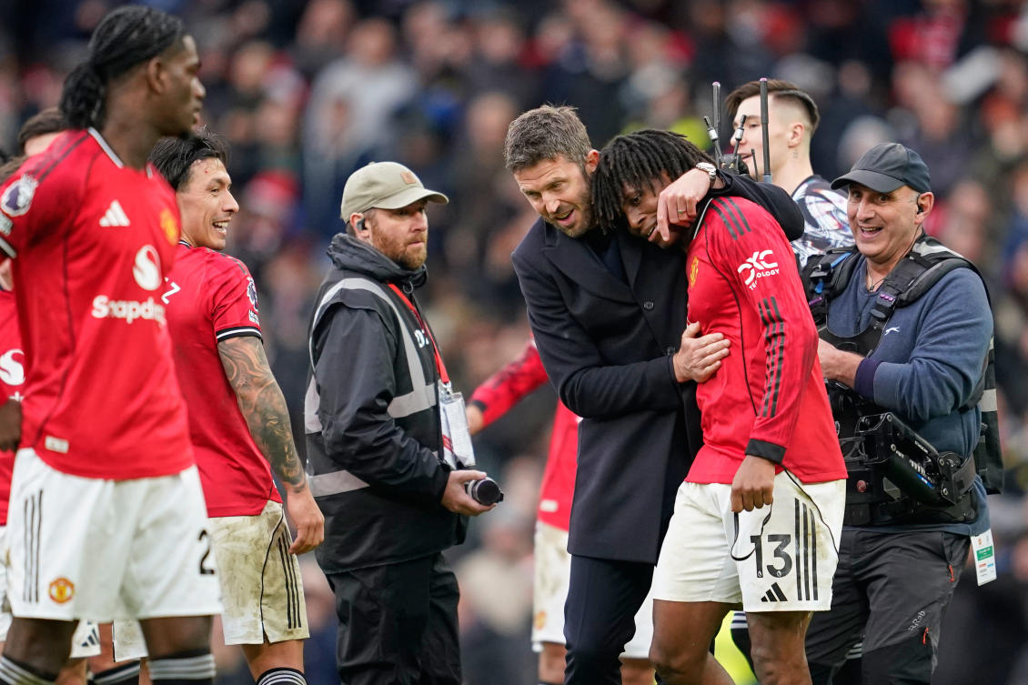 Manchester United’s head coach Michael Carrick celebrates with Patrick Dorgu after their English Premier League match against Manchester City in Manchester, Jan. 17, 2026. (AP)