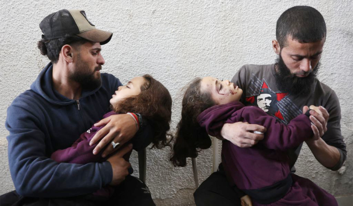 Palestinians mourn as they carry the body of children, killed in an Israeli strike on a school-turned-shelter, at the Al-Shifa hospital in Gaza City on April 23, 2025. (AFP)