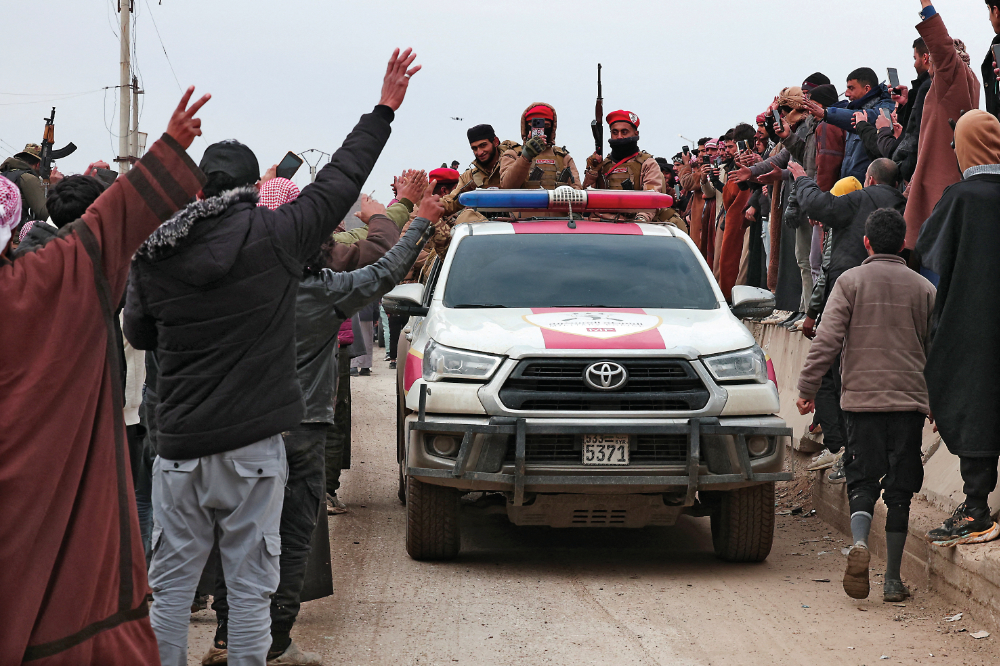 People welcome the Syrian Arab Army on Saturday following the withdrawal of the Kurdish-led Syrian Democratic Forces in Maskanah, Syria. (Reuters)