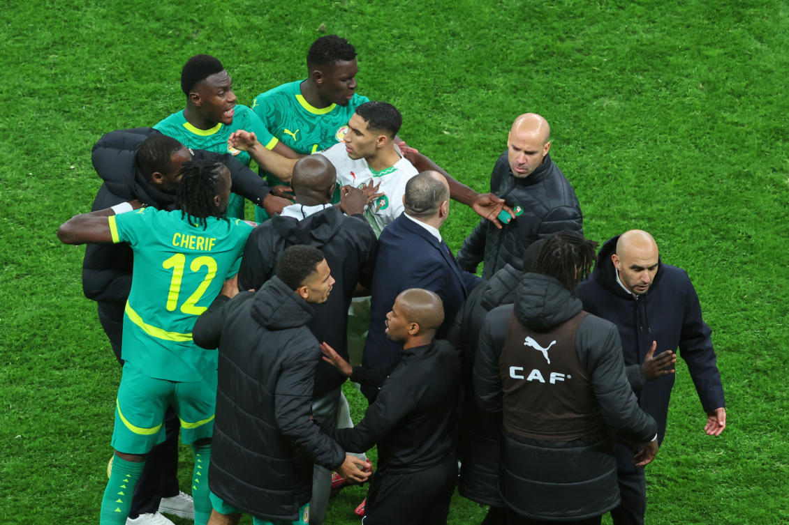 Morocco's Achraf Hakimi, center, clashes with Senegal players after a controversial penalty was awarded to Morocco late on during the Africa Cup of Nations final soccer match between Senegal and Morocco in Rabat, Morocco, Sunday, Jan. 18, 2026. (AP Photo/Youssef Loulidi)
