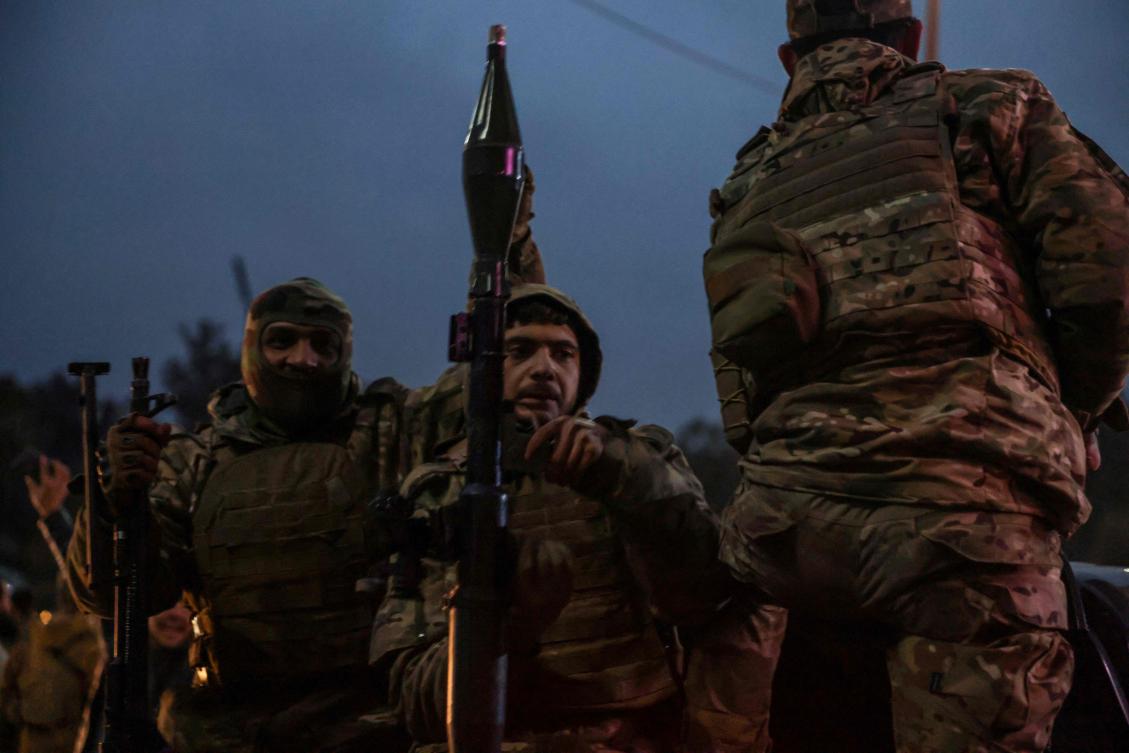 Syrian Defence Force soldiers drive through the streets the northern city of Raqa, on the north bank of the Euphrates River on January 18, 2026. (Photo by Bakr ALkasem / AFP)