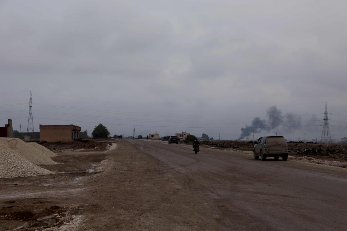 A car and motor bike drive along a road leading to-and-from the northern city of Raqqa, after Syrian Ministry of Defense forces took it over on January 18, 2026. (Photo by Bakr ALkasem / AFP)