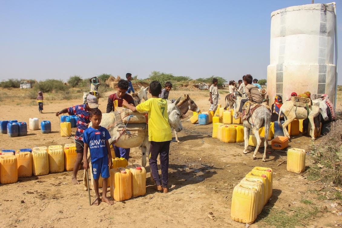 People queue to collect water from a distribution point at a camp for the internally displaced in Yemen's northern Abs district of the Hajjah governorate on January 9, 2025, as the humanitarian crisis in the country continues following the onset of the civil war in 2014. (FILE/AFP)