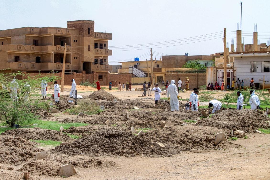 Members of Sudanese Red Crescent exhume remains of people from makeshift graves for reburial in local cemetery in Khartoum’s southern suburb of Al-Azhari after dead were buried in a rush when the area was under RSF control. (File/AFP)