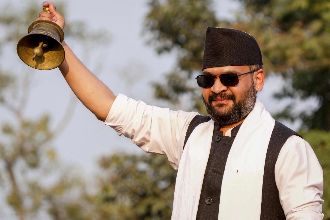 Rastriya Swatantra Party (RSP) election candidate and Kathmandu's former mayor Balendra Shah poses with a bell, the party electoral symbol, during a campaign rally in Janakpur, Nepal. (AFP)