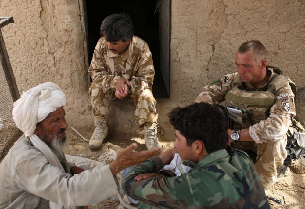A British Army soldier works with Afghan interpreters during a strike operation in August 2008. (Getty Images)