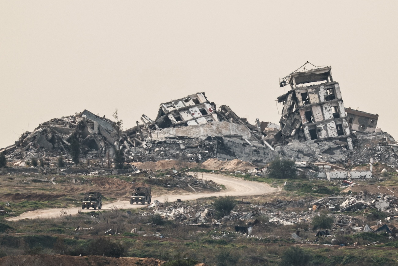 Israeli military vehicles drive past destruction in Gaza, as seen from the Israeli side of the Israel-Gaza border in southern Israel, January 21, 2026. (Reuters)