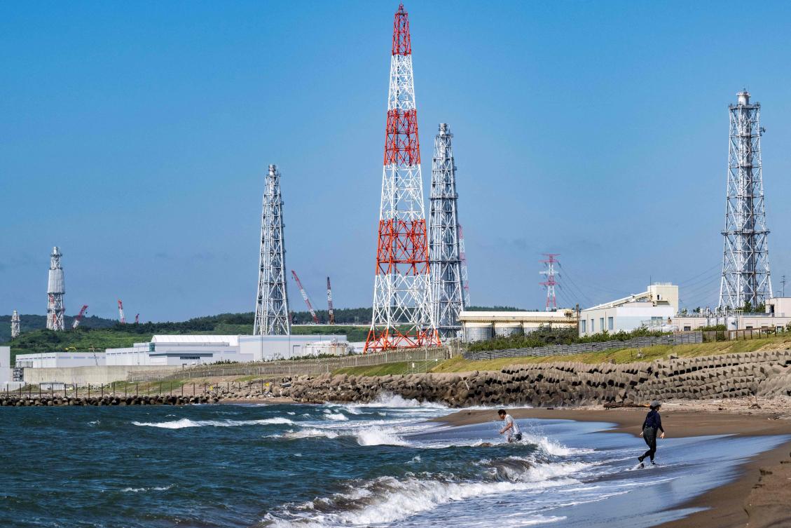 This picture taken on August 5, 2024 shows people visiting Arahama beach in front of the Kashiwazaki-Kariwa nuclear power station in Kashiwazaki, in Japan's Niigata prefecture. (AFP)