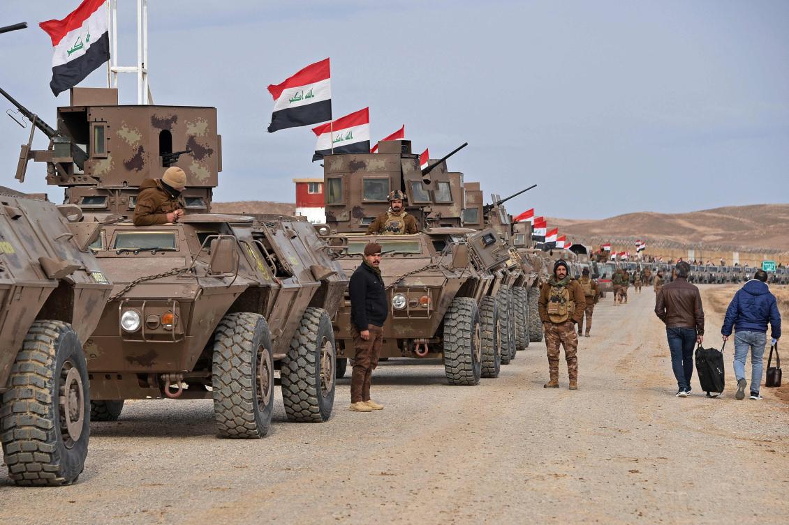 Iraqi border security force personnel stand guard next to their armored vehicles along the border with Syria, in Sinjar district on Thursday. (AFP)