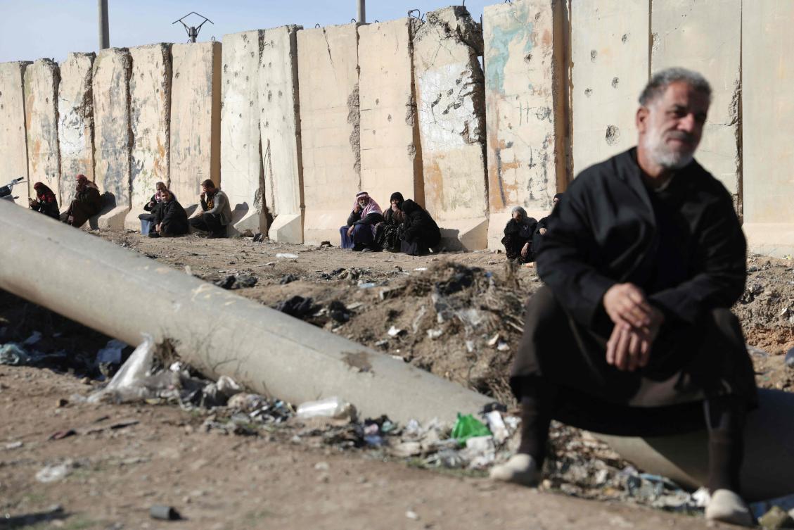 Family members of detainees in Al-Aqtan prison on the outskirts of Raqqa wait outside the facility as they try to have news about their detained relatives on Jan.y 21, 2026.(AFP)